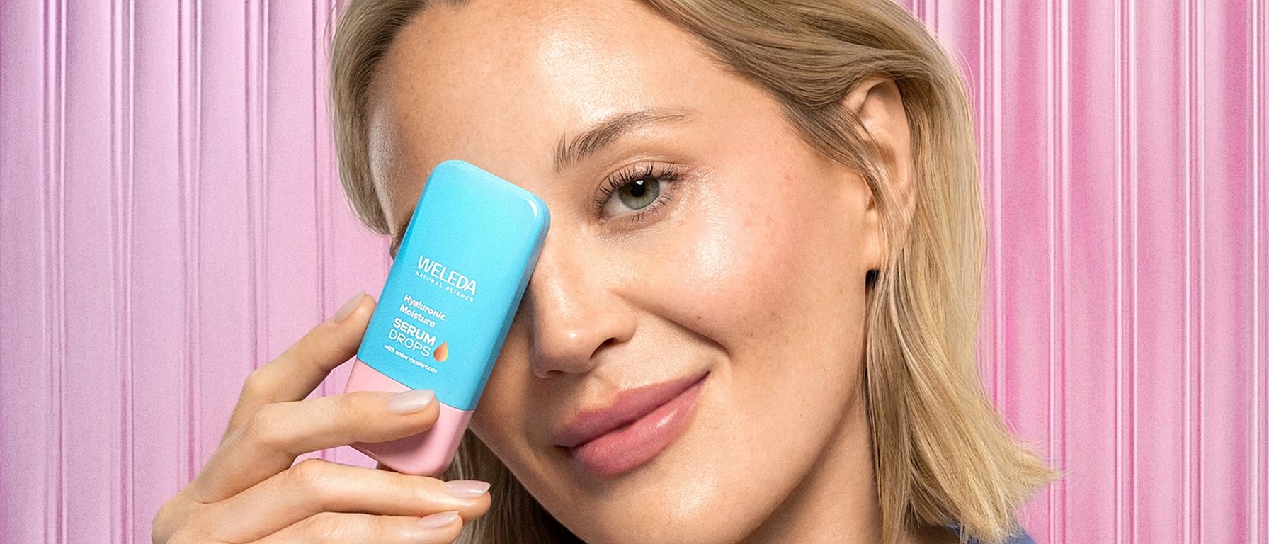 Model is holding Hyaluronic Serum in front of face