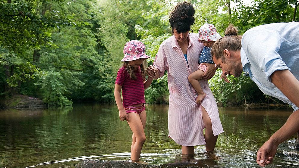 family playing at river